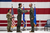 Man pinning a medal on another man
