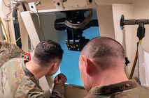 U.S. Air Force 2nd Lt. Antonio Ayala, 91st Missile Maintenance Squadron  (91 MMXS) missile handling team officer in charge (left), and U.S. Air Force Master Sgt. James Porter, 91 MMXS missile maintenance team non-commissioned officer in charge (right), provide final checks during Simulated Electronic Launch Minuteman (SELM) testing at Minot Air Force Base, North Dakota, June 3, 2026.