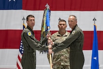 Men holding guidon