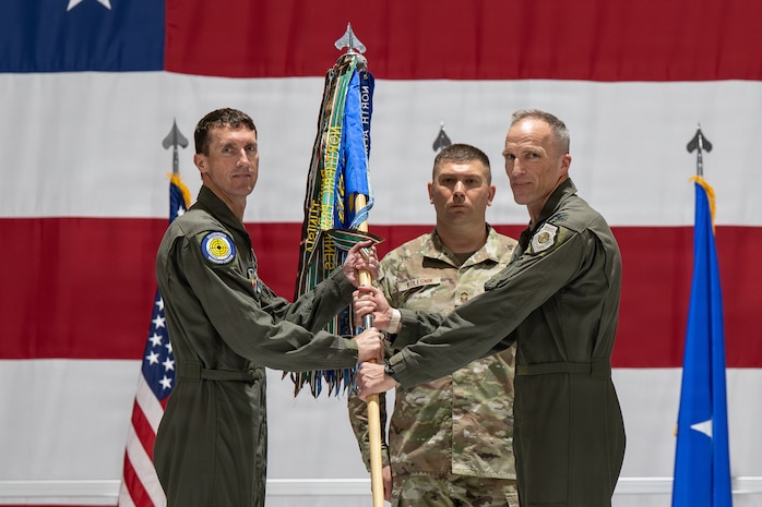 Men holding guidon