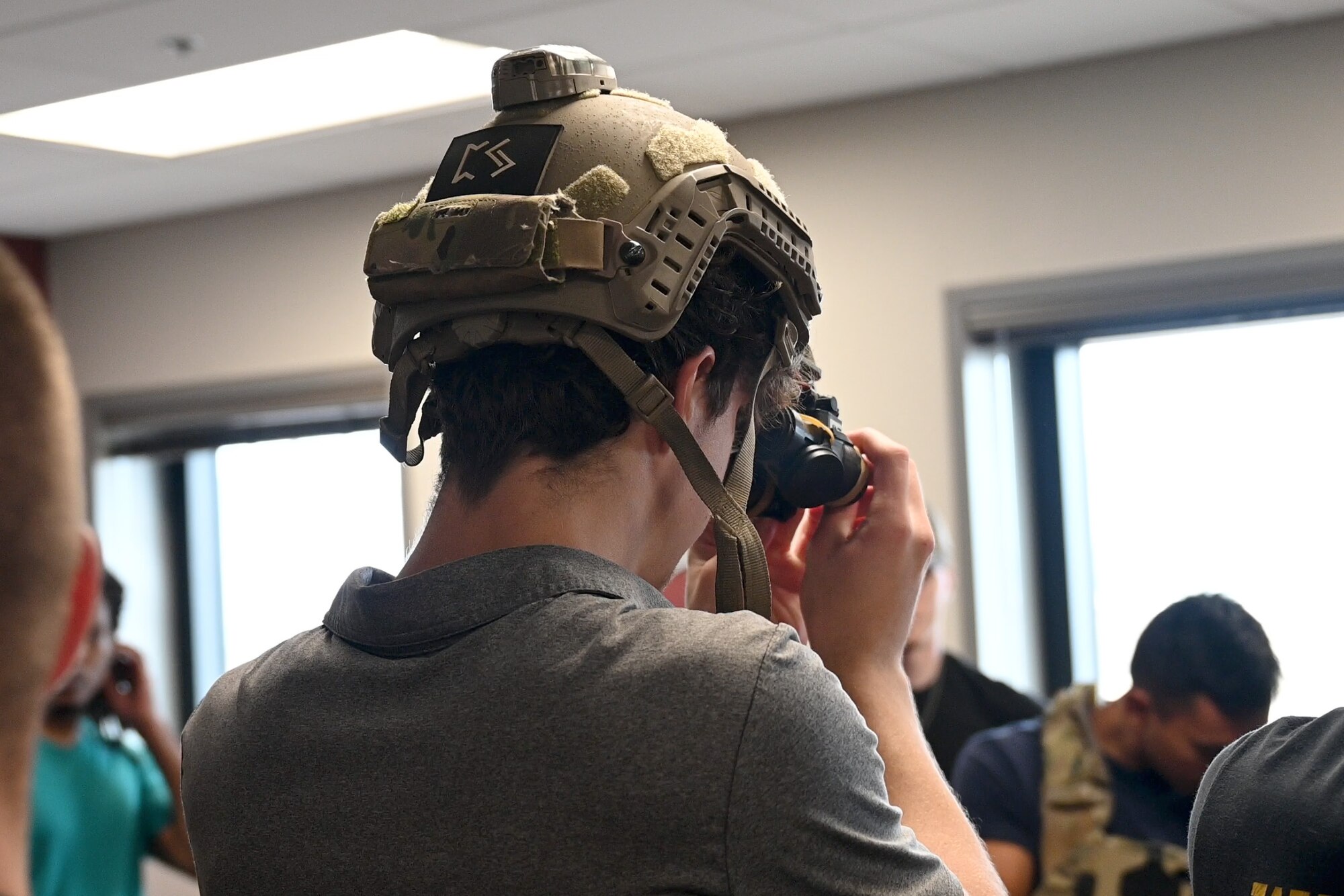 A U.S. Air Force Special Warfare candidate tests equipment during Pararescue Immersion Day at Davis-Monthan Air Force Base, Arizona, June 15, 2026. The event brought together candidates from across Arizona and Southern California interested in AFSPECWAR careers, allowing them to participate in physical training, engage with active-duty operators and learn about the responsibilities of pararescuemen. (U.S. Air Force photo by Airman 1st Class Jaden Kidd)