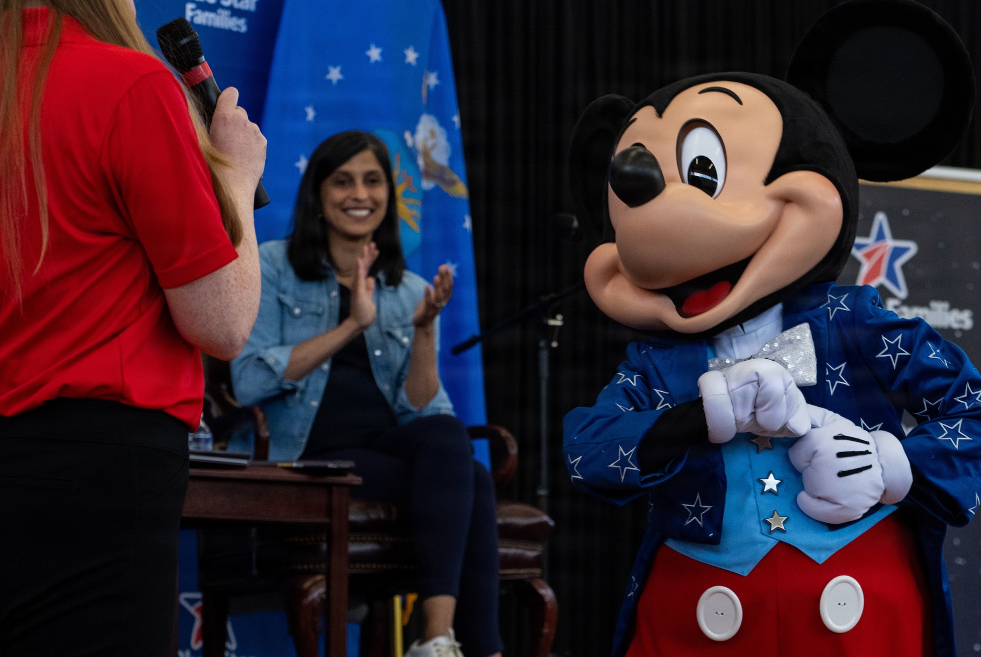 The Second Lady of the United States, Usha Vance, claps alongside Mickey Mouse during a Blue Star Books event at MacDill Air Force Base, Florida, June 16, 2026. Hosted by Blue Star Families in collaboration with The Walt Disney Company, the event provided books and activities for military-connected children and families. (U.S. Air Force photo by Airman 1st Class Nelvis Sera)