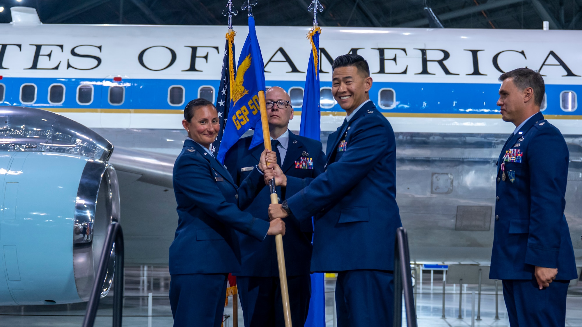 Col. Zarine E. Malesra passes the guidon to Lt. Col. Andrew Lee.