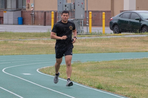 image of a man running on a track.