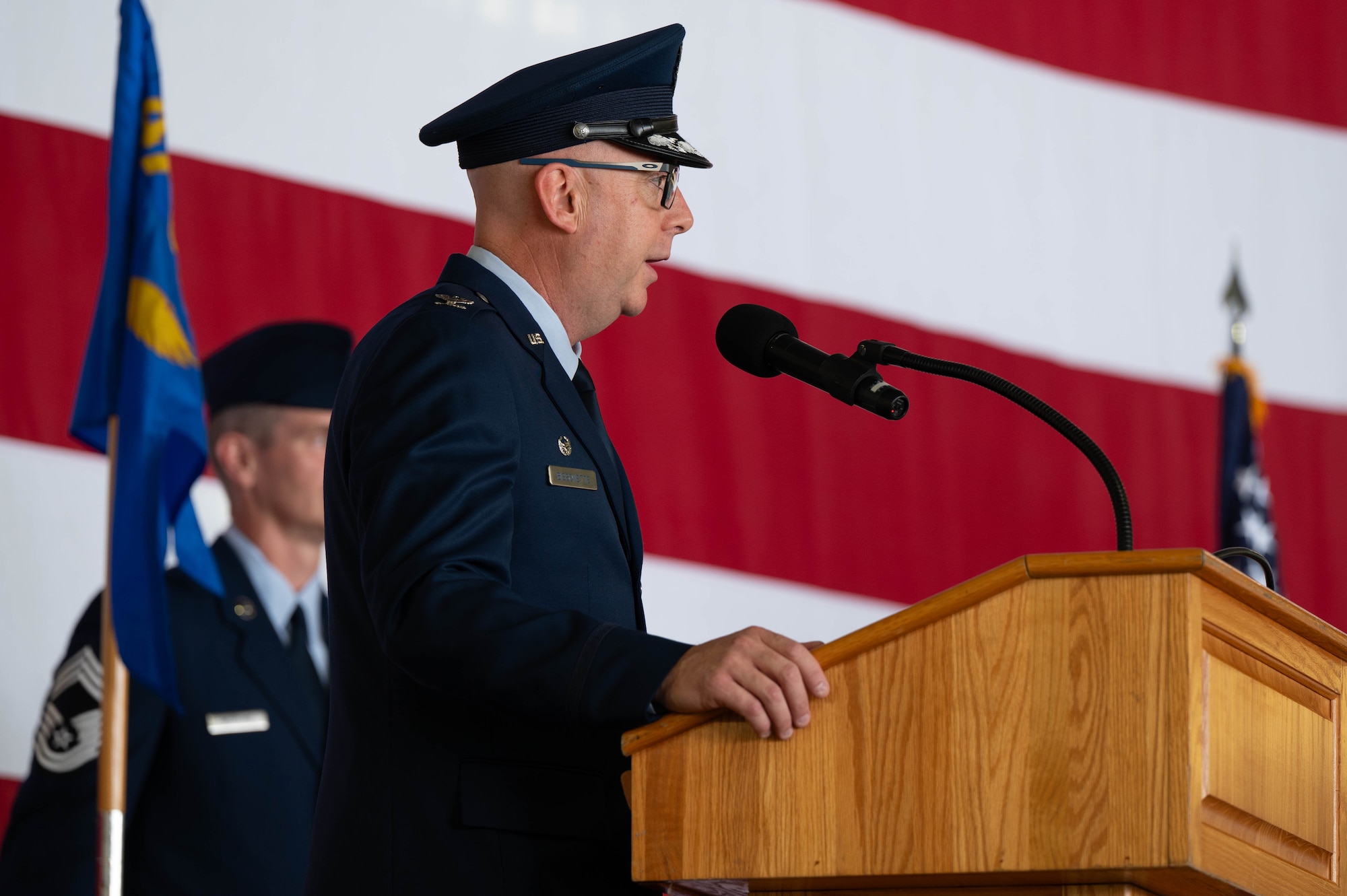 Col. Eric Bissonette, 47th Flying Training Wing commander, delivers remarks at a podium.