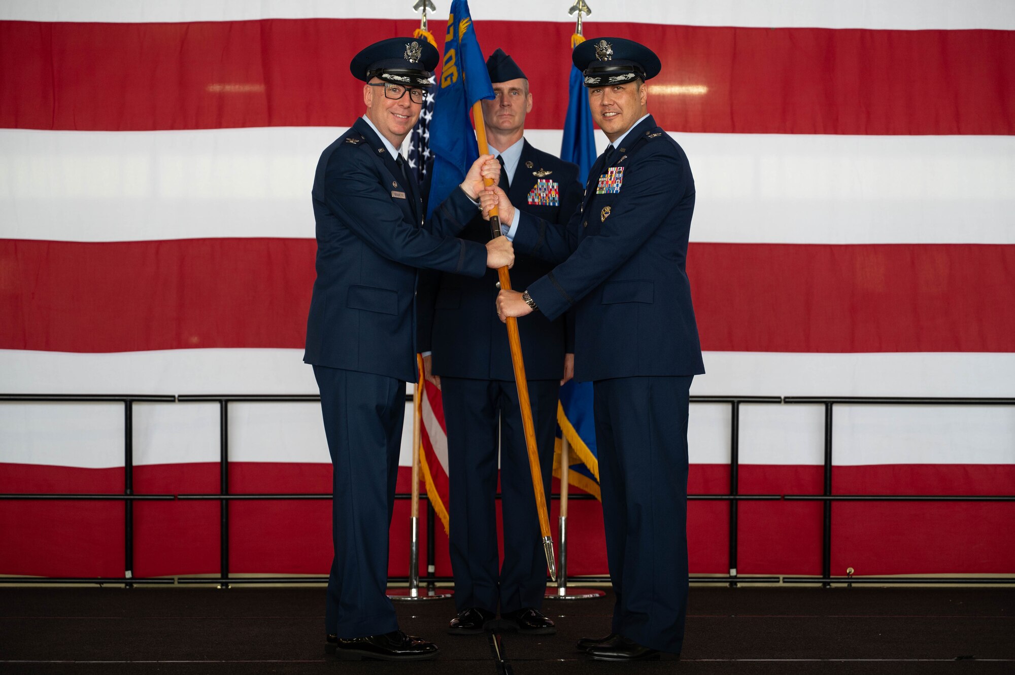 Col. Eric Bissonette presents the squadron guidon to Col. Richard Greig.