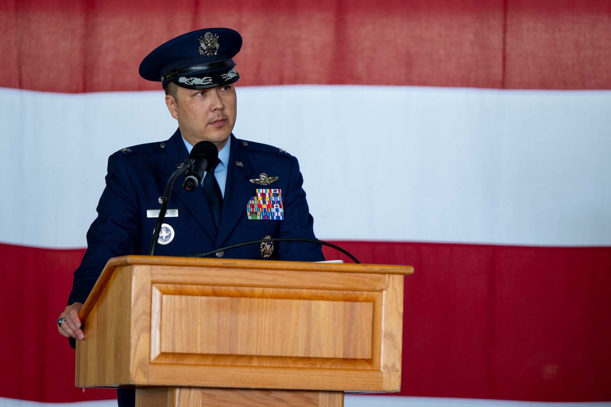 Col. Richard Greig, 47th Operations Group incoming commander, delivers remarks at a podium.