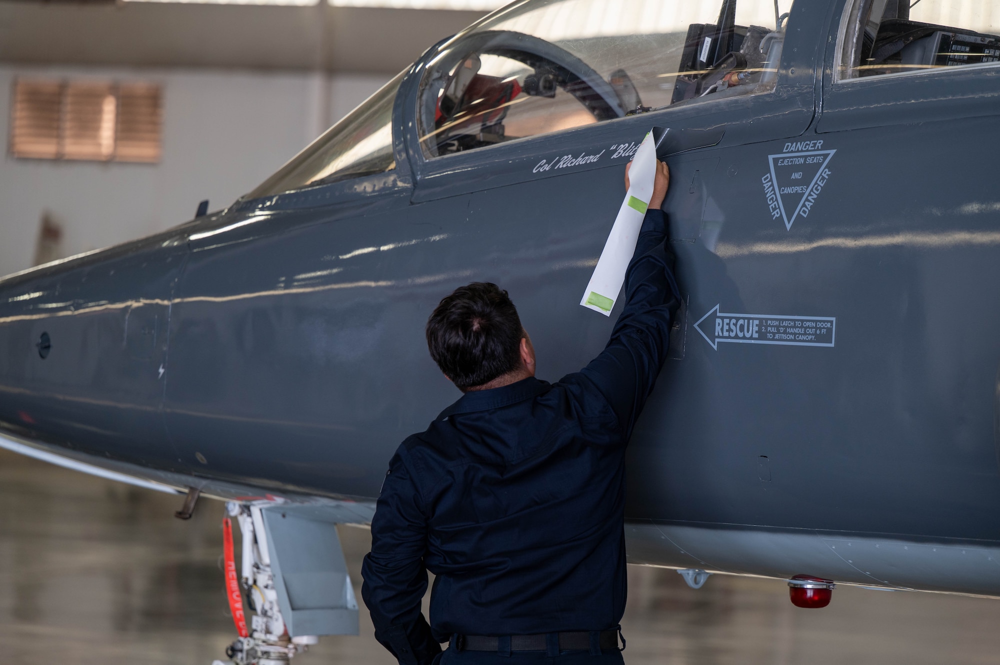 A crew chief from the 47th Maintenance Directorate reveals Col. Richard Greig’s name on the 47th Operations Group flagship aircraft.