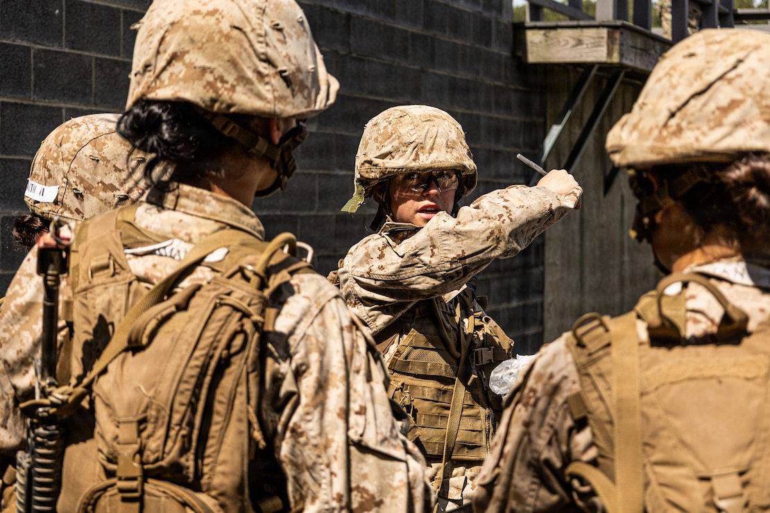U.S. Marine Corps candidate with Company I, briefs her team during the basic reaction course at Marine Corps Base Quantico, Virginia, June 1, 2026. The mission of Officer Candidate School is to educate and train officer candidates in Marine Corps knowledge and skills within a controlled and challenging environment, evaluating and screening individuals, moral, mental, and physical qualities required for commissioning as Marine Corps officers. (U.S. Marine Corps photo by Sgt. Enos Jimenez)