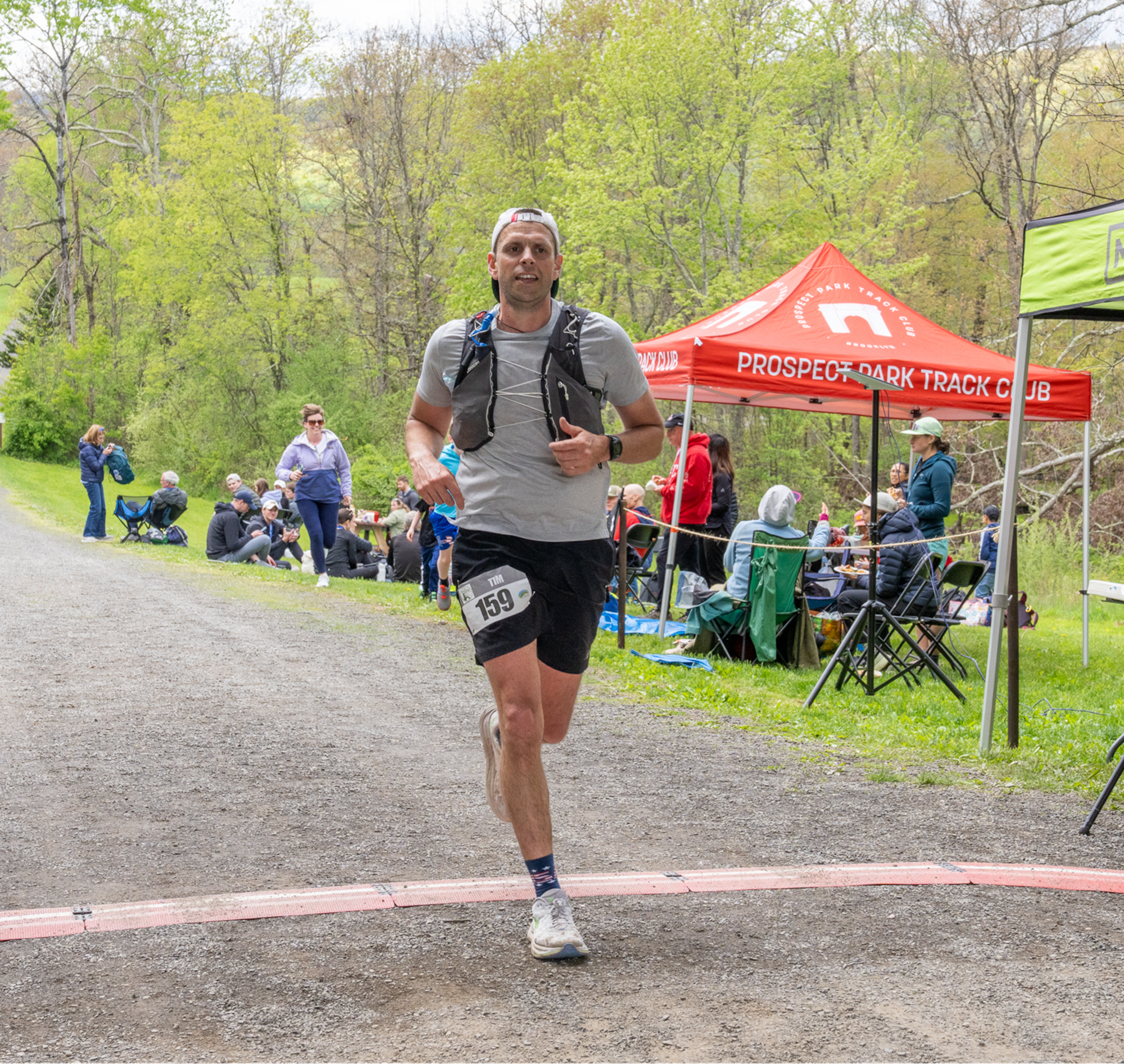 Kosteczko crosses the finish line of an ultra marathon.