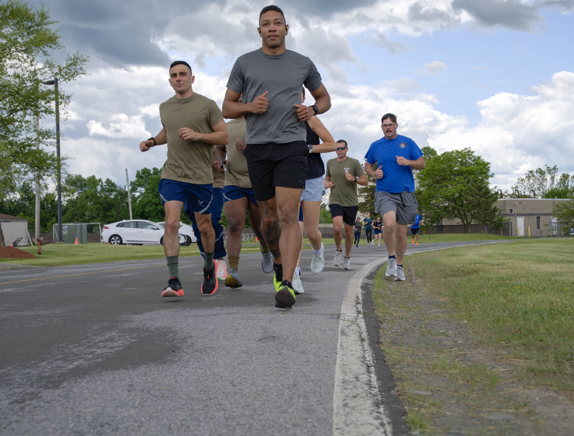 Airmen from the 105th run on the road during a group run.