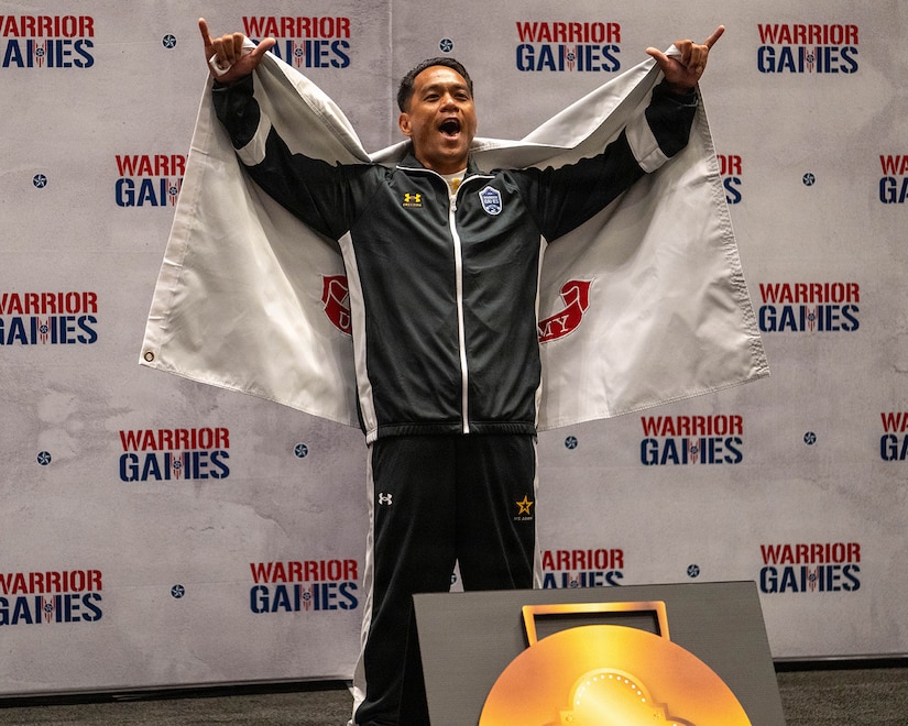 Retired U.S. Army Staff Sgt. Nathaniel Mateo celebrates winning the gold medal in powerlifting during the 2026 Warrior Games at the Henry B. González Convention Center in San Antonio.