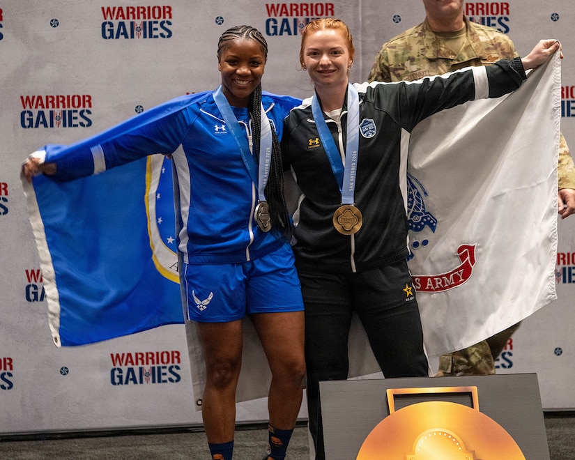 Retired U.S. Air Force Senior Airman Crystal Creek, left, and U.S. Army Staff Sgt. Chelsey Scott celebrate following the powerlifting competition at the 2026 Warrior Games at the Henry B. González Convention Center in San Antonio.