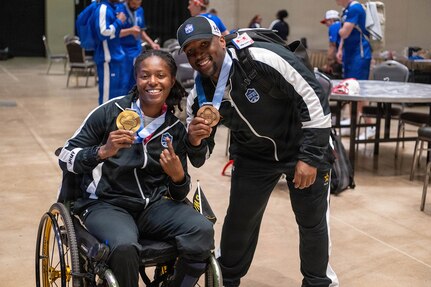 U.S. Army 1st Lt. Jani Merritt, left, and U.S. Army Capt. Tony Smith celebrate after winning medals during the powerlifting competition at the 2026 Warrior Games at the Henry B. González Convention Center in San Antonio, Texas.