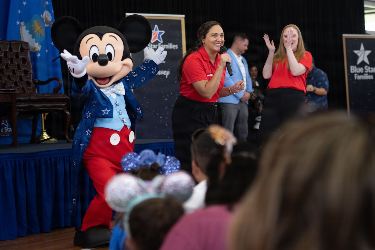 Mickey Mouse performs on stage alongside volunteers during a Blue Star Books event at MacDill Air Force Base, Florida, June 16, 2026. Hosted by Blue Star Families in collaboration with The Walt Disney Company, the event supported Vance’s 2026 Summer Reading Challenge. (U.S. Air Force photo by Airman 1st Class Nelvis Sera)