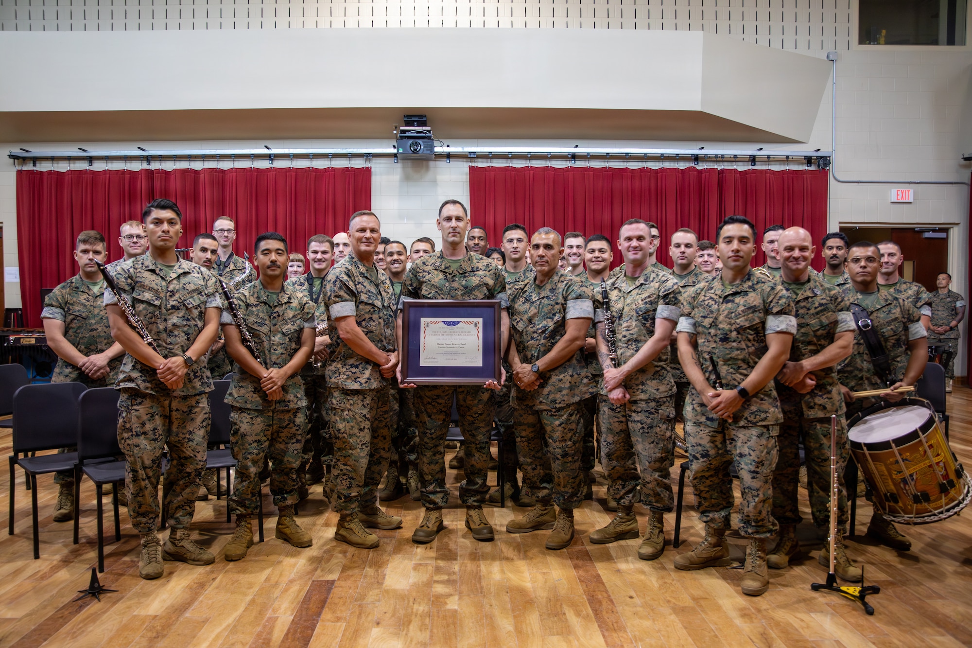 U.S. Marine Corps Lt. Gen. Leonard F. Anderson IV, commander of Marine Forces Reserve and Marine Forces South, and Sgt. Maj. Edwin A. Mota, command senior enlisted advisor of Marine Forces Reserve and Marine Forces South, pose for a photo with the Marine Forces Reserve Band during a ceremony at Marine Corps Support Facility New Orleans, June 4, 2026. Each year only a select few military bands are presented with the Colonel George S. Howard Citation of Musical Excellence award, the highest honor a military concert band can receive. (U.S. Marine Corps photo by Lance Cpl. Nalanie Davila)