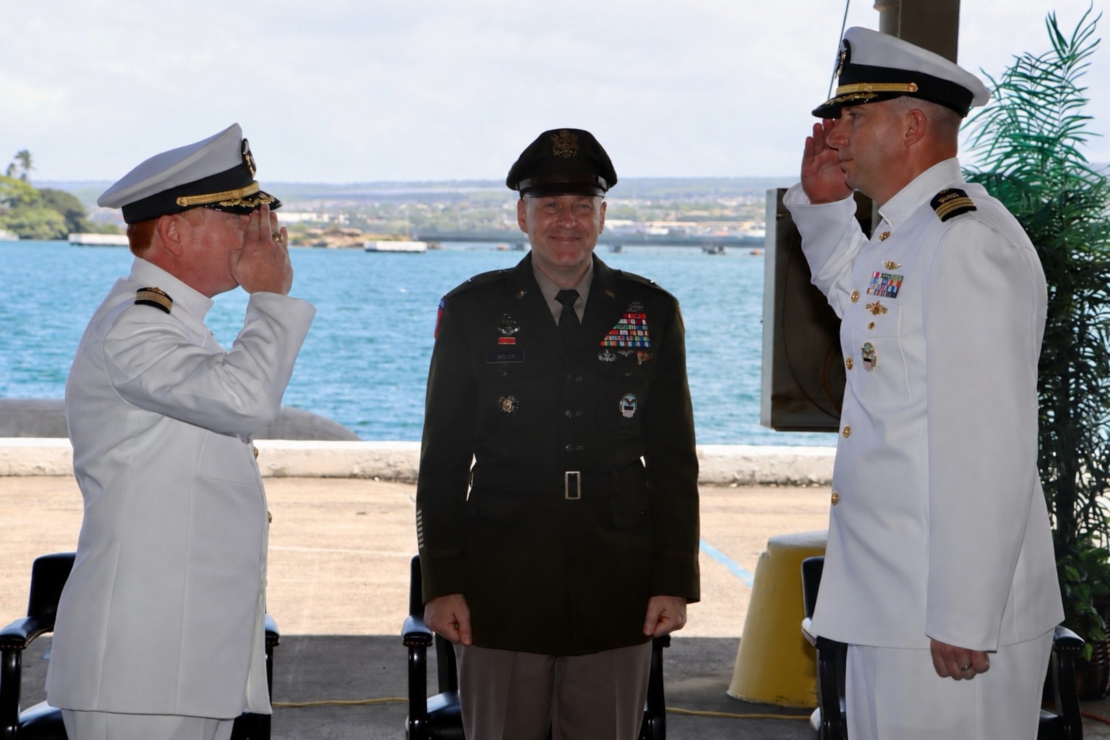 U.S. Navy Cmdr. Thomas Poe, right, incoming commander of Defense Logistics Agency Troop Support Indo-Pacific, and Navy Capt. Ryan Cullinan, left, outgoing commander, participate in a change of command ceremony as U.S. Army Brig. Gen. Sean P. Kelly, commander of DLA Troop Support, center, observes the traditional transfer of authority. The ceremony, held June 5, 2026, marks the formal relinquishment of command from Cullinan to Poe. DLA Troop Support Indo-Pacific provides comprehensive logistics, supply, and support services to joint warfighters across the Pacific theater. U.S. Navy photo by Wesley Burgos, public affairs specialist, NAVSUP FLC Pearl Harbor.