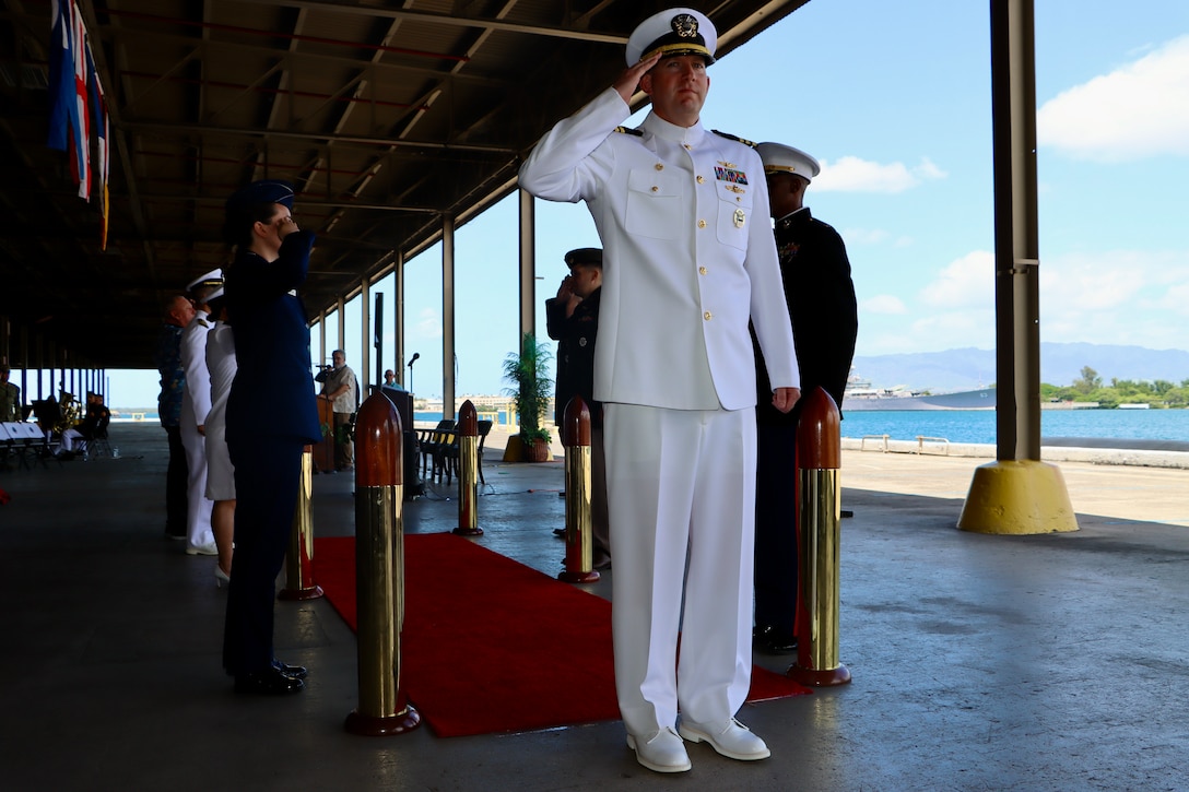 U.S. Navy Cmdr. Thomas Poe, incoming commander of Defense Logistics Agency Troop Support Indo-Pacific, departs the stage at the conclusion of the unit's change of command ceremony, June 5, 2026. Poe assumed leadership of the regional command from Navy Capt. Ryan Cullinan during the event, which was officiated by Army Brig. Gen. Sean P. Kelly. U.S. Navy photo by Wesley Burgos.