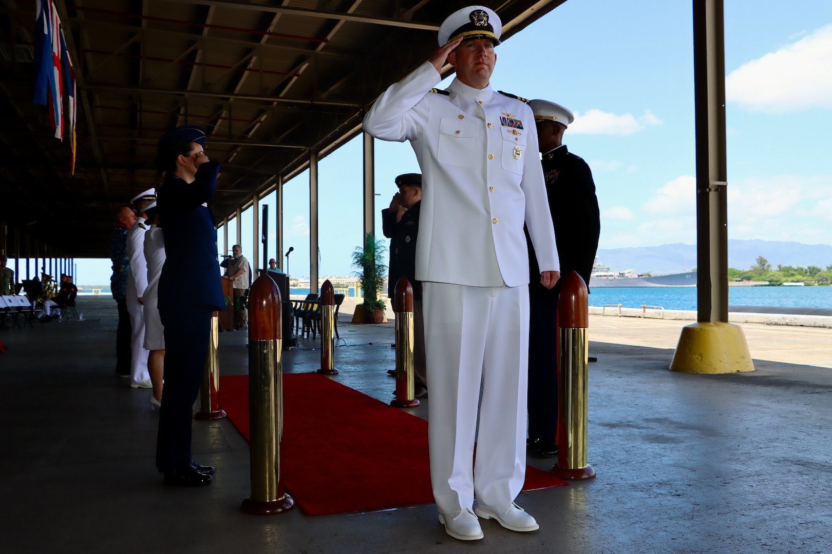 U.S. Navy Cmdr. Thomas Poe, incoming commander of Defense Logistics Agency Troop Support Indo-Pacific, departs the stage at the conclusion of the unit's change of command ceremony, June 5, 2026. Poe assumed leadership of the regional command from Navy Capt. Ryan Cullinan during the event, which was officiated by Army Brig. Gen. Sean P. Kelly. U.S. Navy photo by Wesley Burgos.