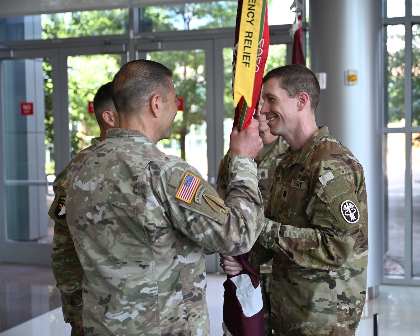 Col. Mark Jacques, commander of Carl R. Darnall Army Medical Center, receives the guidon from outgoing Soldier Recovery Unit commander Lt. Col. John Burns during a change of command ceremony at CRDAMC on June 18. The passing of the guidon symbolizes the transfer of authority and responsibility.