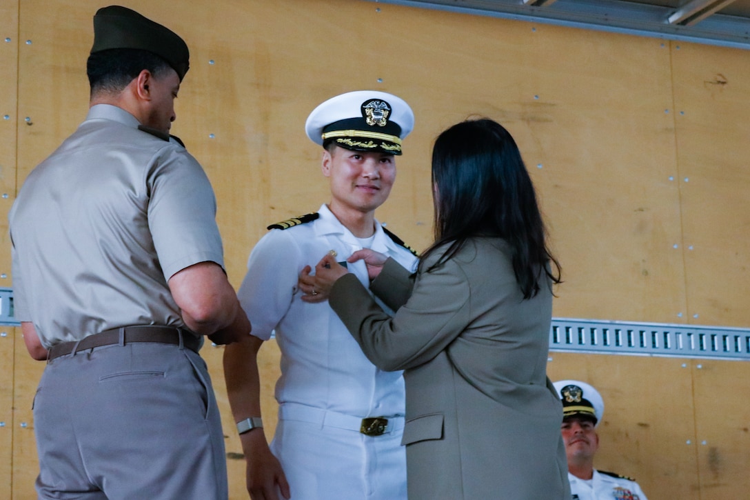 people wearing military uniforms stand on stage