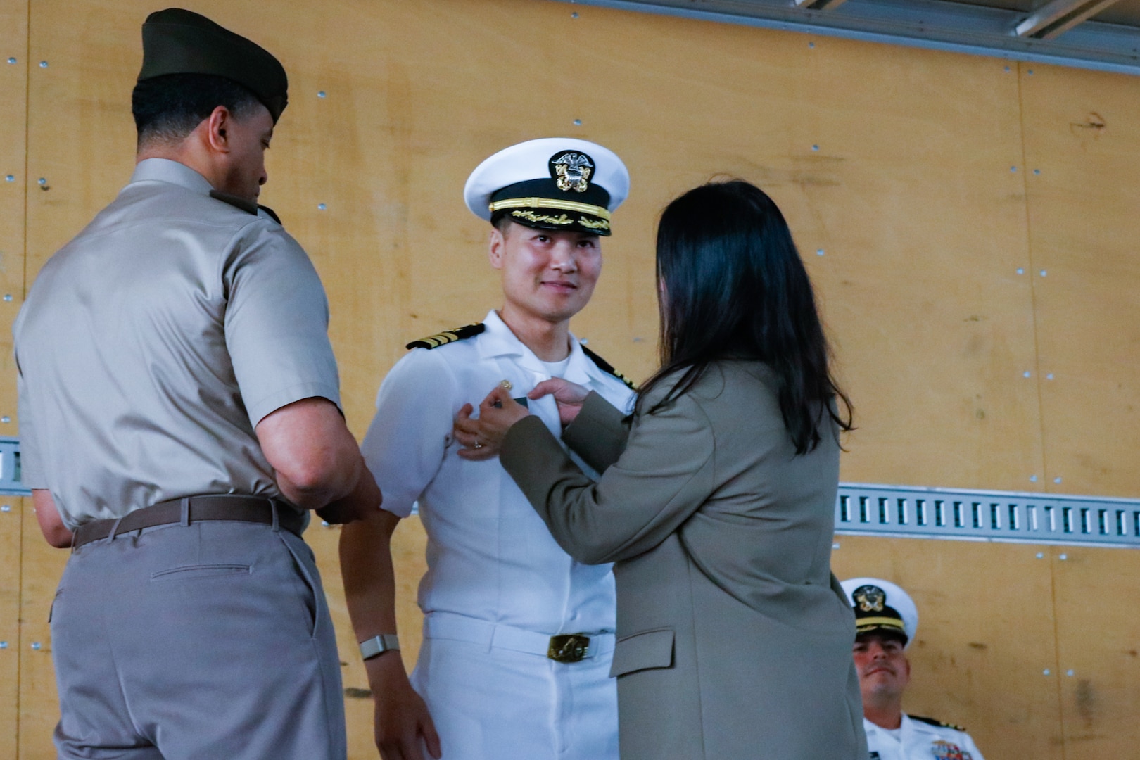 people wearing military uniforms stand on stage