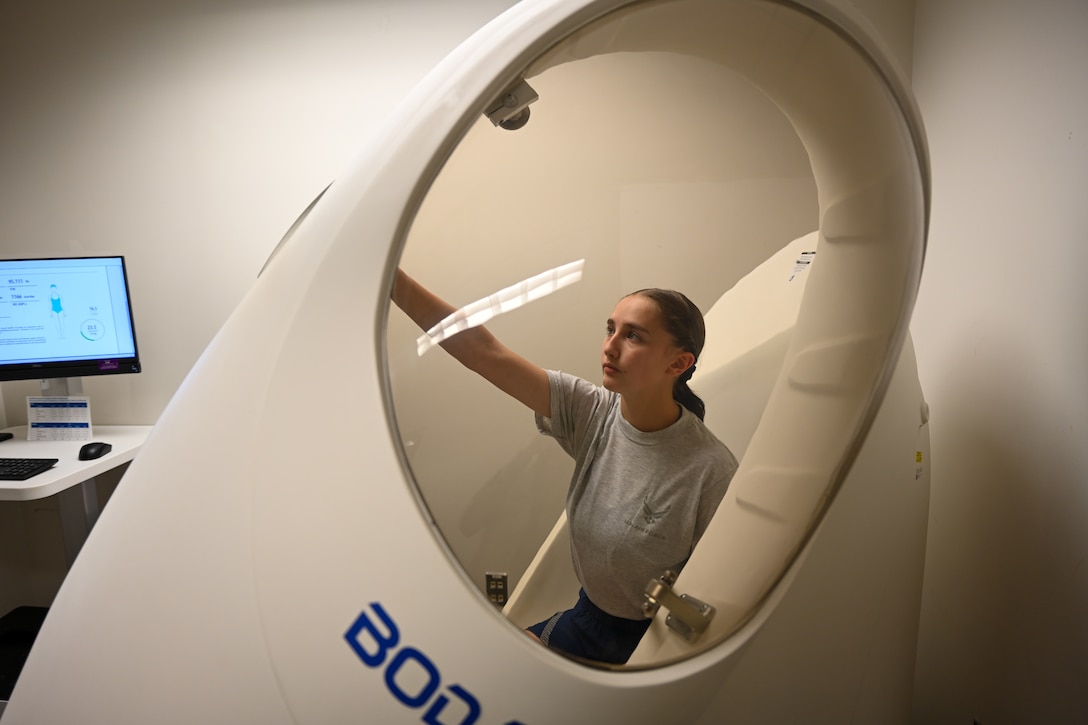 Airman closes door to BOD POD machine. (U.S. Air Force photo by Airman 1st Class Donnell Ramsey)