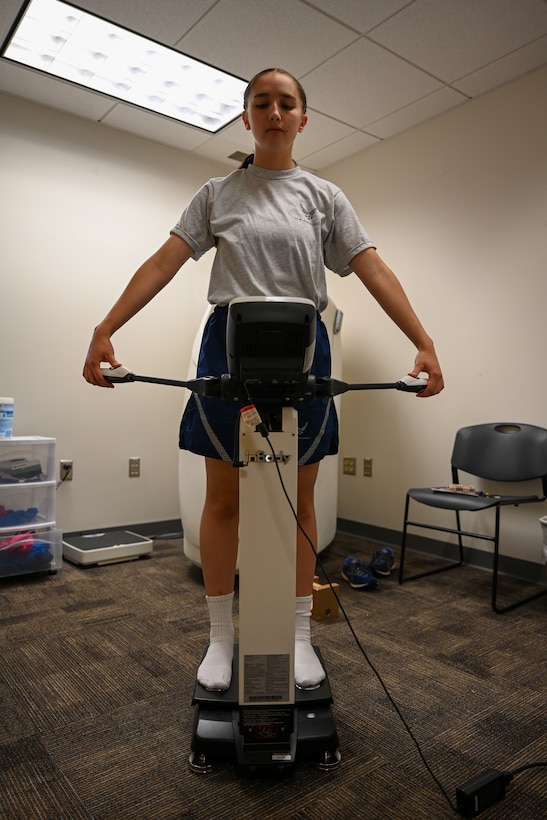 Airman holds handles to machine. (U.S. Air Force photo by Airman 1st Class Donnell Ramsey)