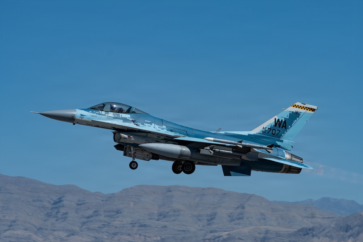 An F-16C Fighter Falcon assigned to the 64th Aggressor Squadron takes off for a mission in support of the U.S. Air Force Weapons School Integration at Nellis Air Force Base, Nev., June 9, 2026. Aggressor pilots are highly trained in both U.S. and adversary tactics, providing realistic threat replication that enhances readiness for U.S. and allied forces during high-end training exercises. (U.S. Air Force Photo by Airman 1st Class Jasmine Thomas)