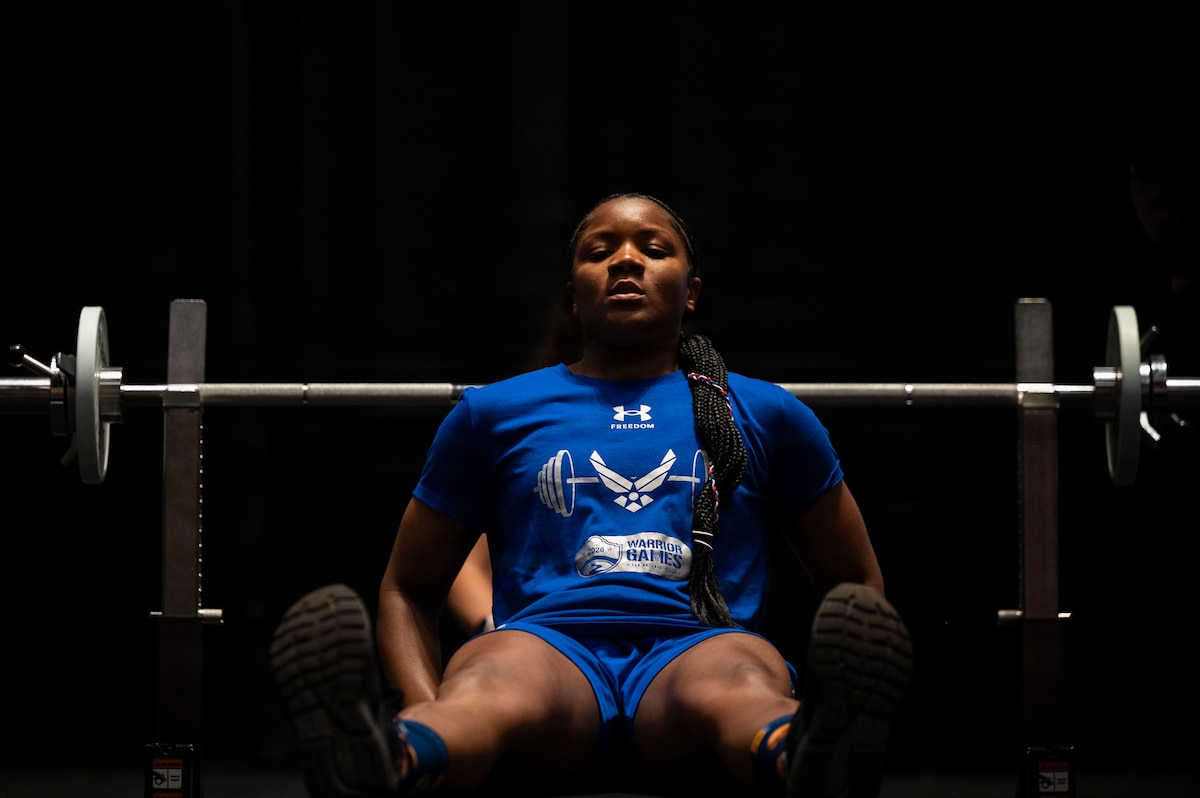 Senior Airman Crystal Creek, U.S. Air Force Warrior Games competitor, prepares for her lift during the powerlifting portion of The Warrior Games. The games celebrate the determination, strength, and resilience of wounded, ill, and injured service members and veterans. The 2026 Warrior Games take place June 13-20, 2026, in San Antonio, Texas, bringing together nearly 200 wounded, ill, and injured service members and veterans from the Army, Marine Corps, Navy/Coast Guard, Air Force/Space Force, and Special Operations Command to compete across multiple adaptive sporting events. (U.S. Air Force Photo by Tech. Sgt. Shawn White)