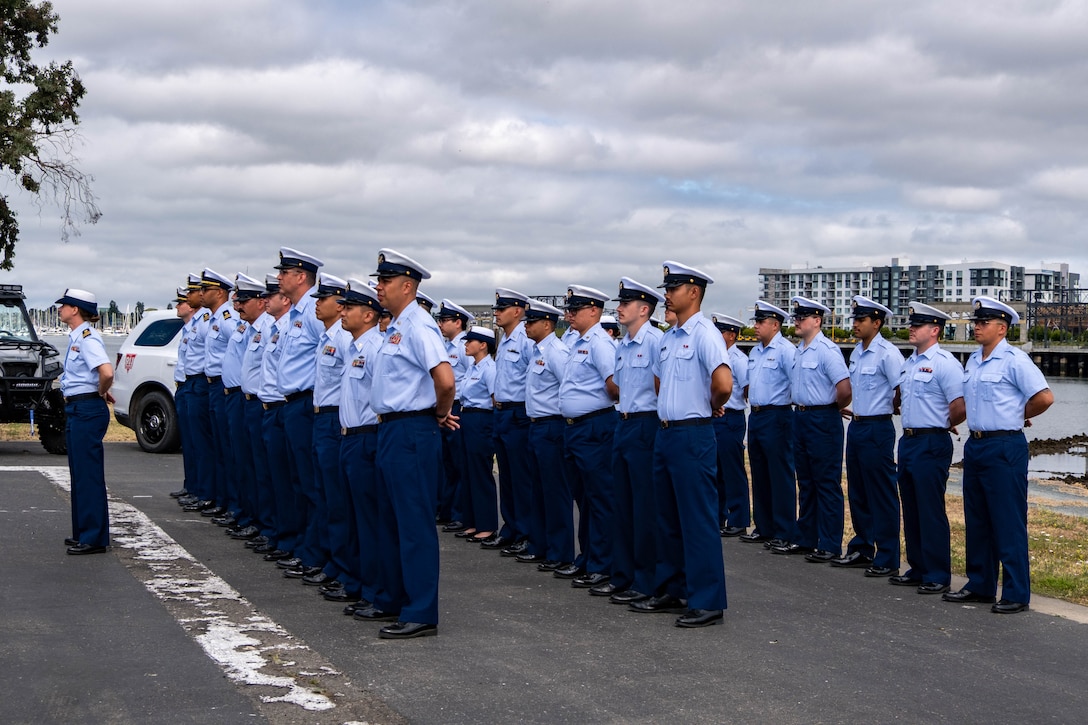 Base Alameda personnel stand at parade rest during change of command ceremony.