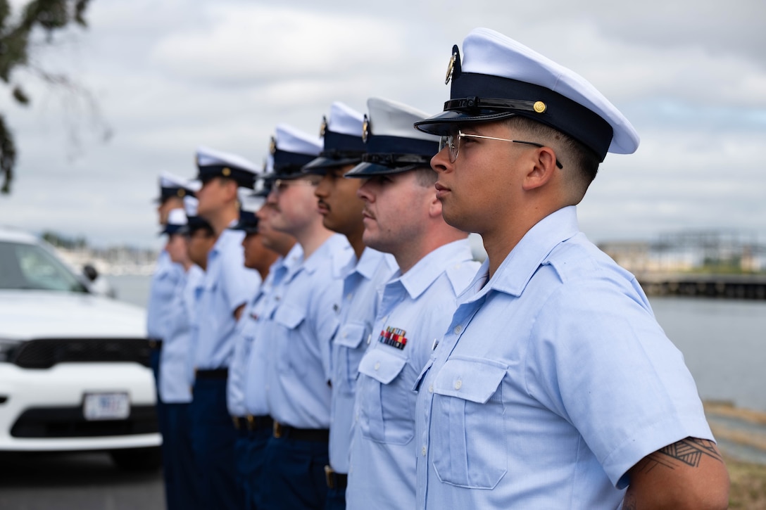 Base Alameda personnel stand at parade rest during change of command ceremony.