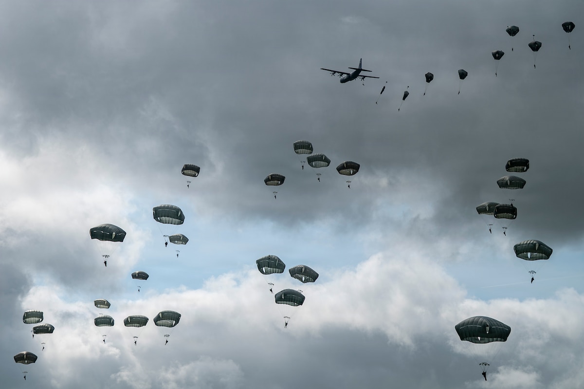 Paratroopers from the U.S. Air Force, Army and allied forces jump into a drop zone at La Fiere, France, June 7, 2026. D-Day 82 commemorates the courage and sacrifice of Allied forces who fought for freedom, reminding us of the enduring strength of alliances and shared responsibility. (U.S. Air Force photo by Tech. Sgt. Shawn White)