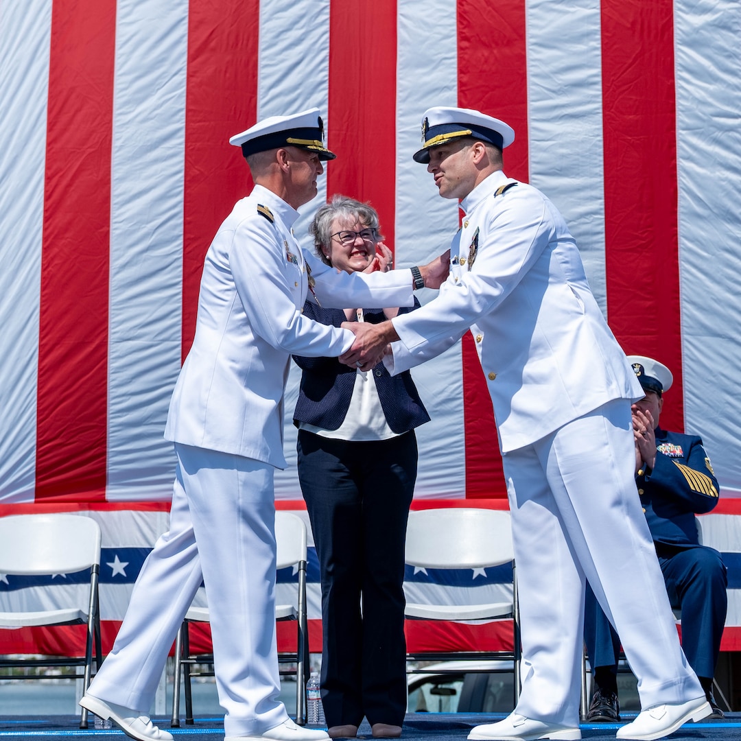 Capt. Corey Braddock and Capt. Joseph Graham shake hands during Base Alameda change of command ceremony.