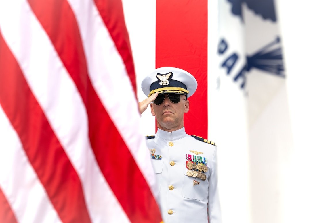 Capt. Corey Braddock salutes during Base Alameda change of command ceremony.