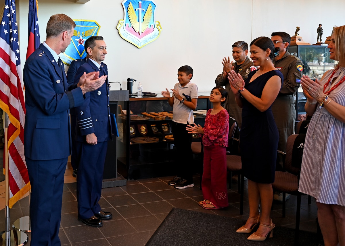 Attendees applaud following the presentation of the Air Force Meritorious Service medal to Chilean air force Col. Marcelo Garcia, System of Cooperation Among the American Air Forces (SICOFAA) undersecretary general, at Davis-Monthan Air Force Base, Arizona, June 5, 2026. During Garcia’s two years serving as undersecretary general, he supported multinational emergency management efforts across the hemisphere, including responses to major flooding in Colombia and Ecuador, Hurricane Melissa in Jamaica, and wildfires in the United States. (U.S. Air Force photo by Staff Sgt. Abbey Rieves)