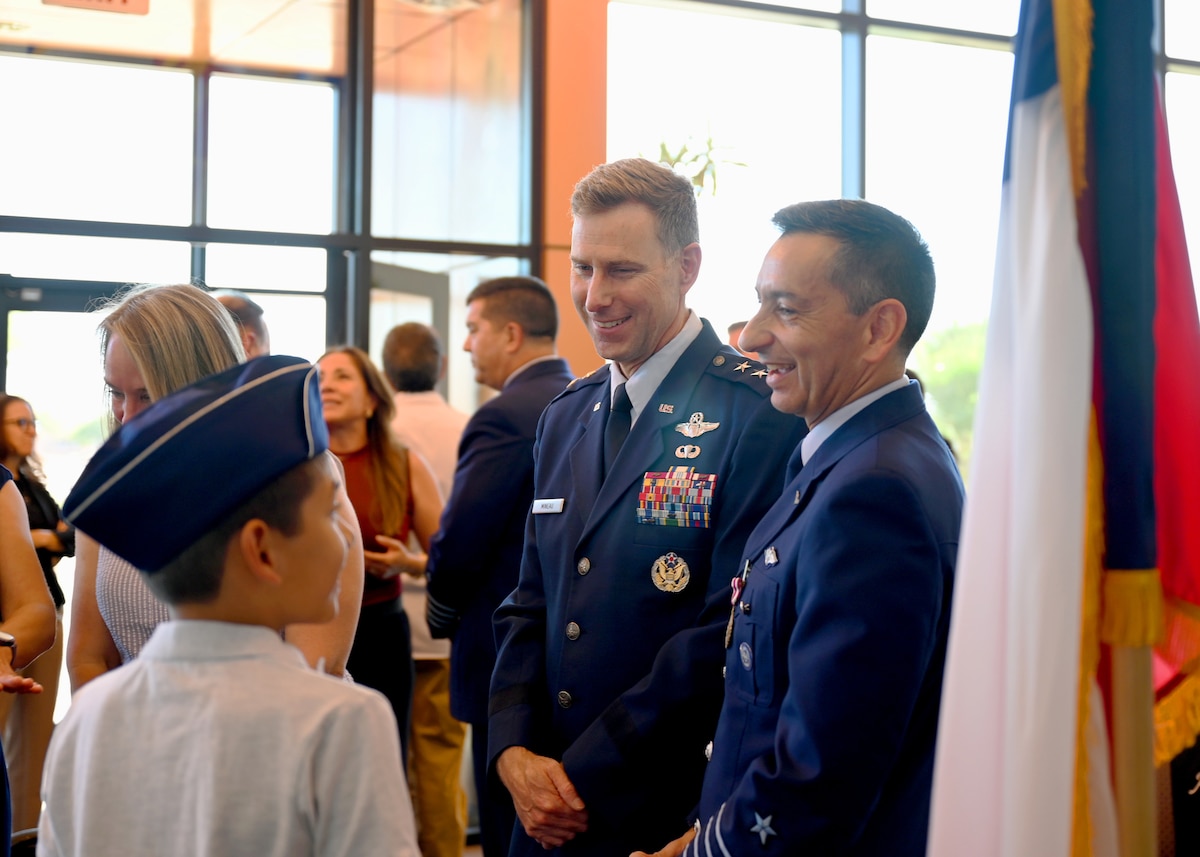 U.S. Air Force Maj. Gen. David Mineau, 12th Air Force, Air Forces Southern (AFSOUTH) commander, center, and Chilean air force Col. Marcelo Garcia, System of Cooperation Among the American Air Forces (SICOFAA) undersecretary general, right, interact with Garcia’s son after an Air Force Meritorious Service Medal presentation ceremony at 12th Air Force, Air Forces Southern (AFSOUTH) headquarters, on Davis-Monthan Air Force Base, Arizona, June 5, 2026. Garcia served as SICOFAA undersecretary for two years, helping advance cooperation among member nations while supporting the organization's long-term strategic vision. (U.S. Air Force photo by Staff Sgt. Abbey Rieves)