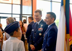 U.S. Air Force Maj. Gen. David Mineau, 12th Air Force, Air Forces Southern (AFSOUTH) commander, center, and Chilean air force Col. Marcelo Garcia, System of Cooperation Among the American Air Forces (SICOFAA) undersecretary general, right, interact with Garcia’s son after an Air Force Meritorious Service Medal presentation ceremony at 12th Air Force, Air Forces Southern (AFSOUTH) headquarters, on Davis-Monthan Air Force Base, Arizona, June 5, 2026. Garcia served as SICOFAA undersecretary for two years, helping advance cooperation among member nations while supporting the organization's long-term strategic vision. (U.S. Air Force photo by Staff Sgt. Abbey Rieves)