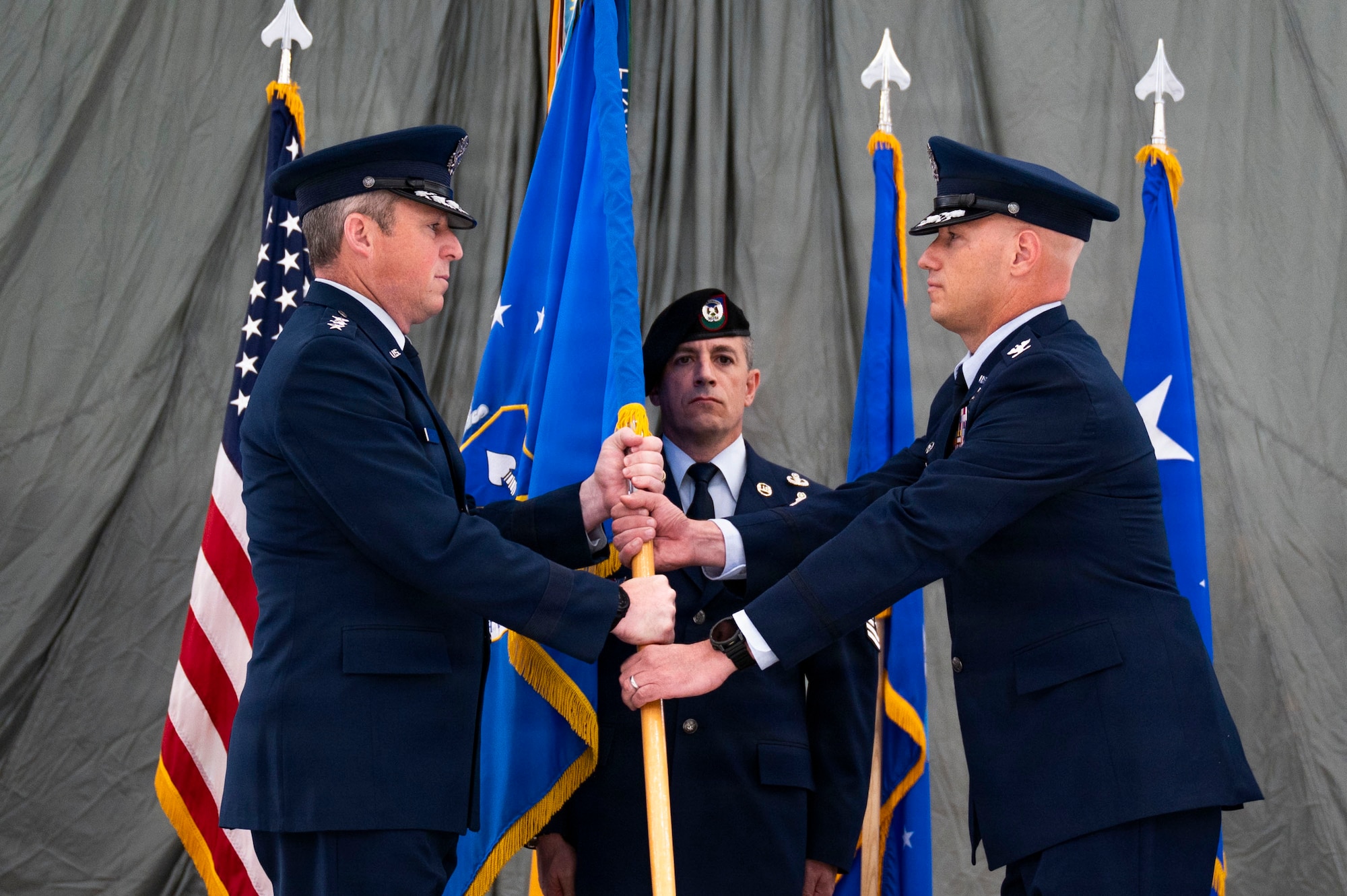 U.S. Air Force Lt. Gen. Mike Conley, left, commander of Air Force Special Operations Command, passes the guidon from U.S. Air Force Col. Brett Cassidy, right, 27th Special Operations Wing commander, during a change of command ceremony at Cannon Air Force Base, New Mexico, June 18, 2026. Conley facilitated the transfer of command fromCol. Robert Johnston, 27th SOW outgoing commander, to Cassidy, 27th SOW incoming commander. (U.S. Air Force photo by Staff Sgt. Corinna Morlan)