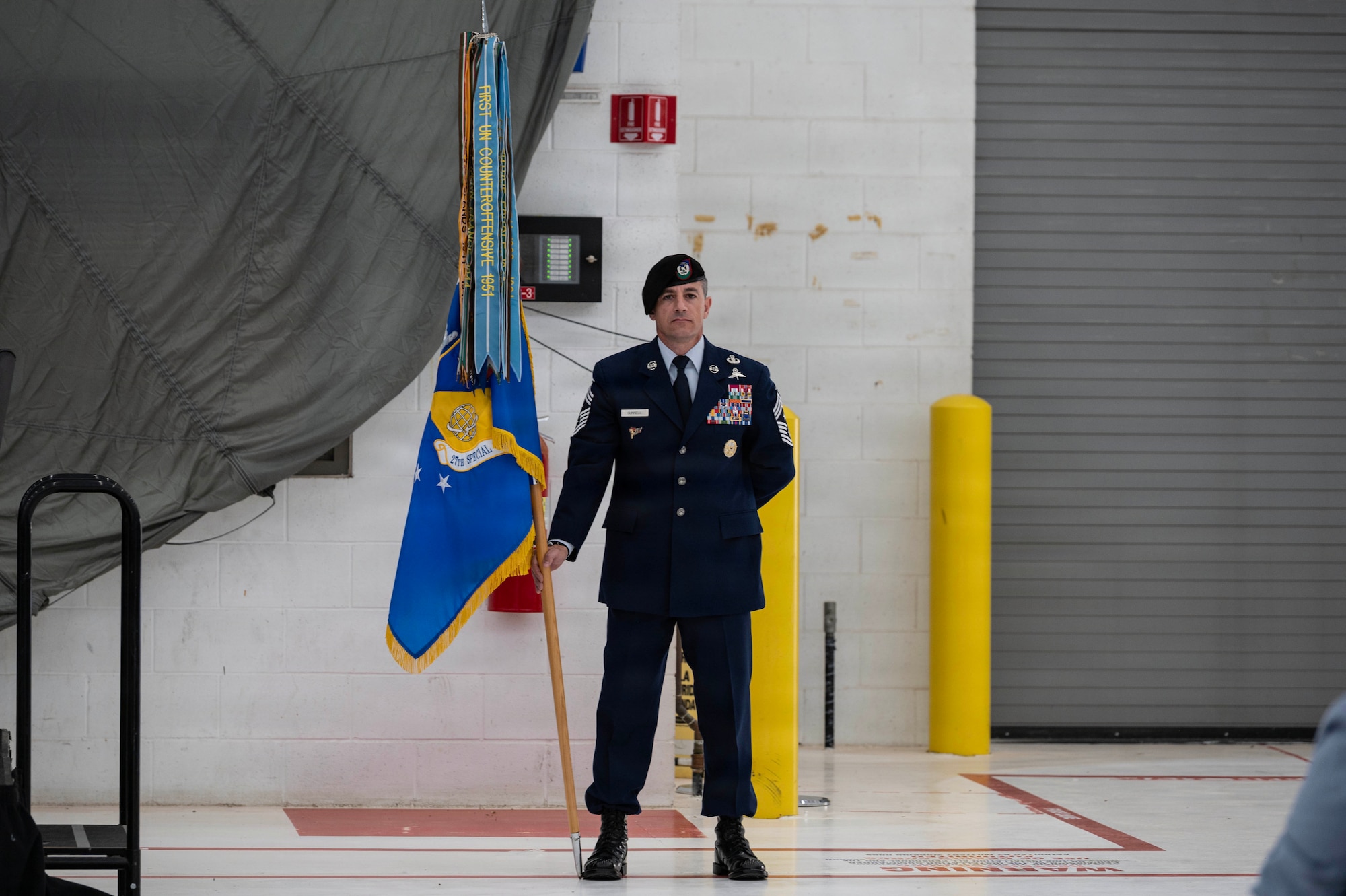 Chief Master Sgt. Thomas Gunnell, 27th Special Operations Wing command chief, holds the 27th SOW guidon during the wing change of command at Cannon Air Force Base, New Mexico, June 18, 2026. During the ceremony, U.S. Air Force Col. Robert Johnston relinquished command of the 27th SOW to U.S. Air Force Col. Brett Cassidy, marking the formal transfer of authority, responsibility and accountability from one commander to another. (U.S. Air Force photo by Staff Sgt. Abbigayle Williams)