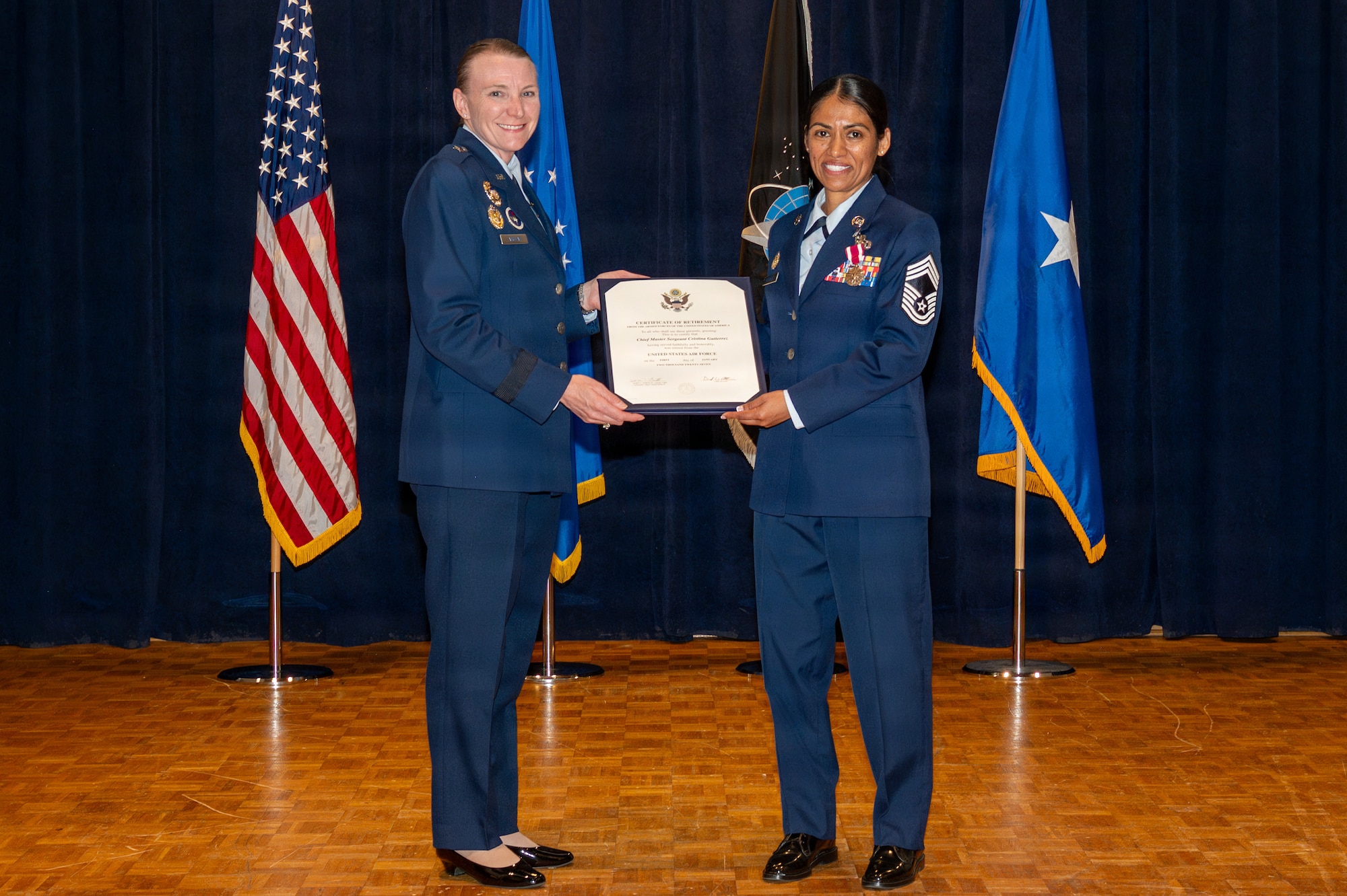 Two people stand and hold a certificate