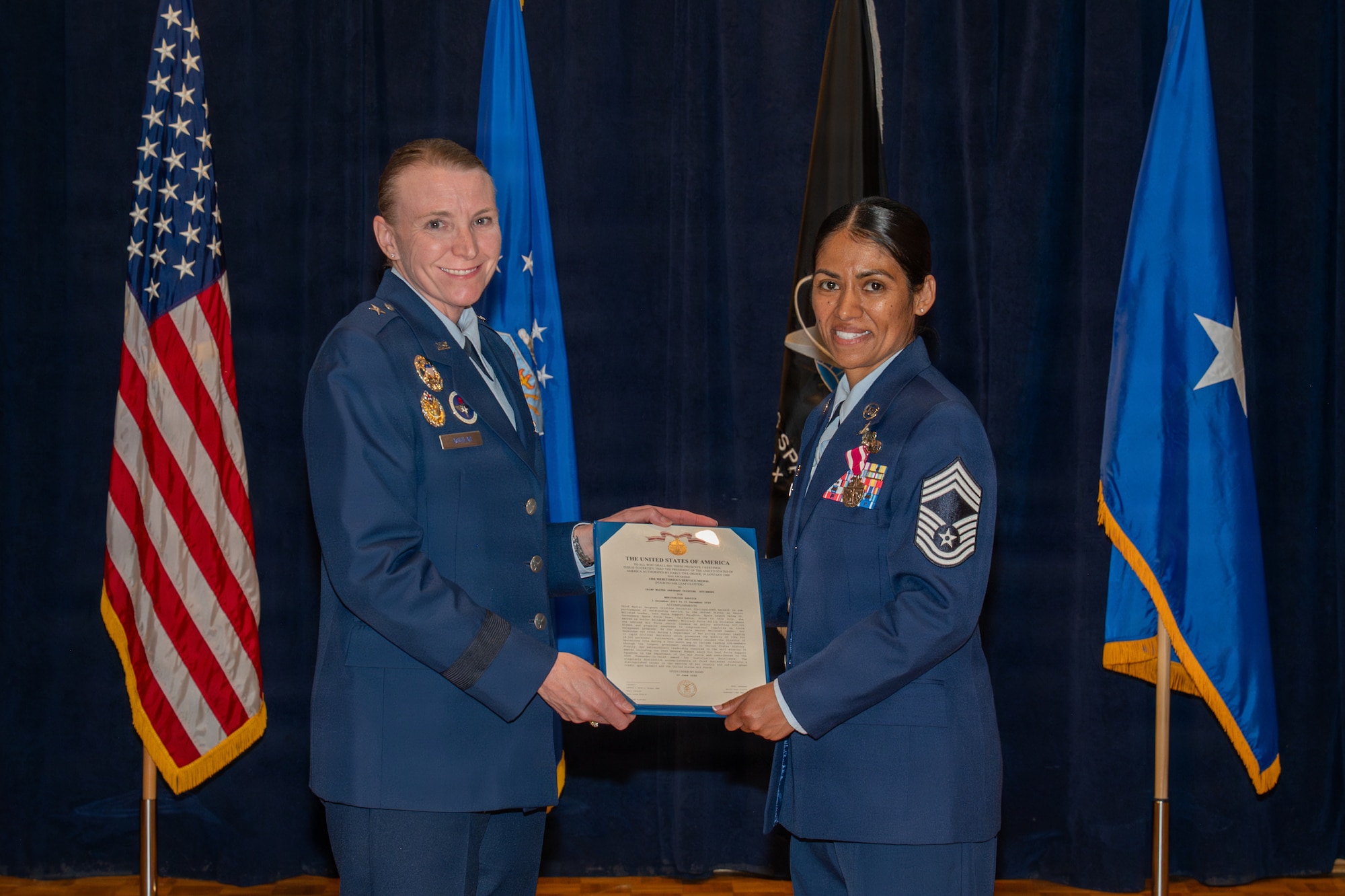 Two people stand and hold a certificate