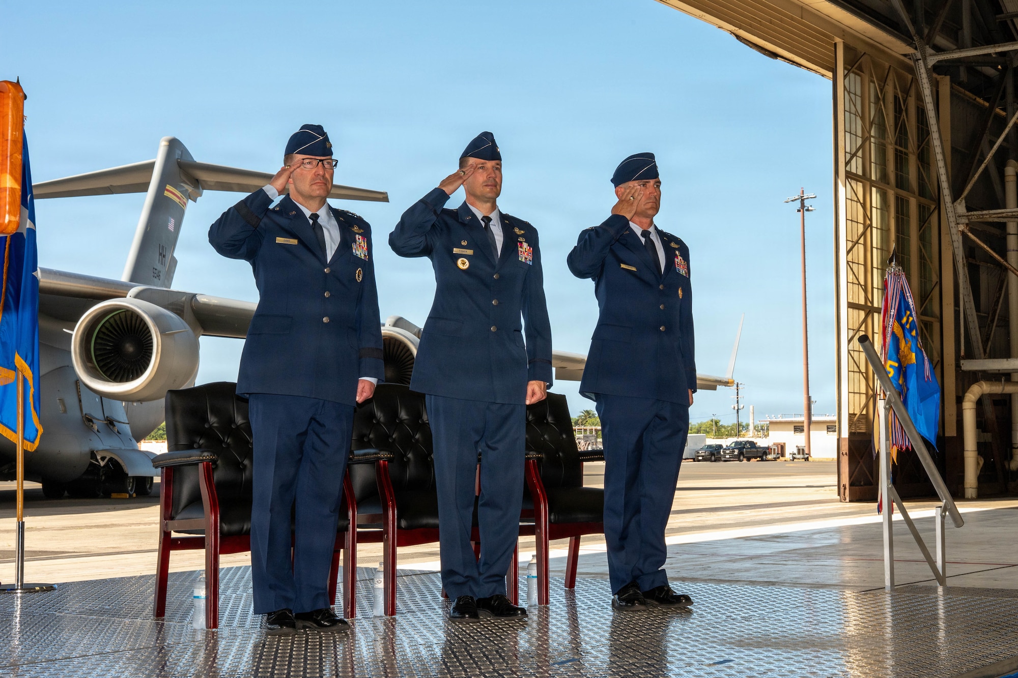 From left, U.S. Air Force Lt. Gen. Robert Davis, Alaskan North American Aerospace Defense Command Region, Alaskan Command and Eleventh Air Force commander, Col. Garrett Fisher, outgoing 15th Wing commander, and Col. Kyle Clinton, incoming 15th Wing commander, salute during the wing change of command ceremony at Joint Base Pearl Harbor-Hickam, Hawaii, June 18, 2026. Davis served as the presiding officer for the ceremony, the senior authority responsible for formally transferring command authority from the outgoing commander to the incoming commander. (U.S. Air Force photo by Senior Airman Lauren Torres)