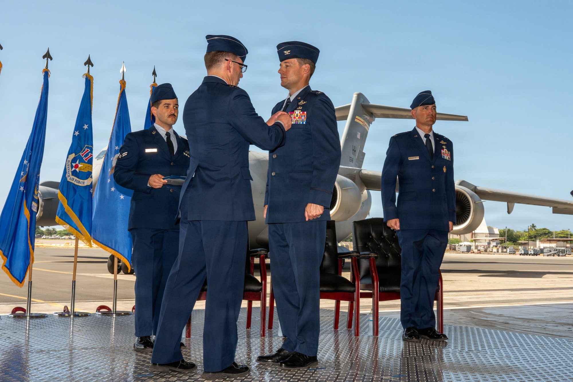 U.S. Air Force Lt. Gen. Robert. Davis, Alaskan North American Aerospace Defense Command Region, Alaskan Command and Eleventh Air Force commander,  pins the Legion of Merit medal on Col. Garrett Fisher, outgoing 15th Wing commander, during the wing change of command ceremony at Joint Base Pearl Harbor-Hickam, Hawaii, June 18, 2026. Fisher served as the commander of the 15 WG since July 23, 2024. (U.S. Air Force photo by Senior Airman Lauren Torres)
