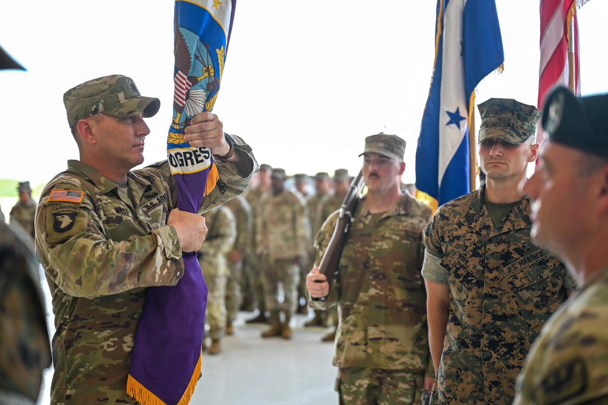 U.S. Army Command Sgt. Maj. Thomas West, Joint Task Force-Bravo senior enlisted leader, holds the Joint Task Force-Bravo guidon during the JTF-Bravo change of command and responsibility ceremony at Soto Cano Air Base, Honduras, June 18, 2026. West assumed responsibility of JTF-Bravo and will serve alongside Col. David Webb, JTF-Bravo commander, leading the task force into the next chapter. (U.S. Air Force photo by Staff Sgt. Ethan Sherwood)