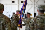 U.S. Army Command Sgt. Maj. John Diggles, outgoing Joint Task Force-Bravo senior enlisted leader, passes the JTF-Bravo guidon to Col. Robert Snyder, outgoing JTF-Bravo commander, during the JTF-Bravo change of command and responsibility ceremony at Soto Cano Air Base, Honduras, June 18, 2026. Diggles passing the guidon symbolizes his relinquishment of responsibility for JTF-Bravo, ending his time as the senior enlisted leader. (U.S. Air Force photo by Staff Sgt. Ethan Sherwood)