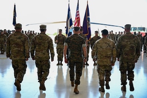 U.S. Marine Gen. Francis Donovan, commander of U.S. Southern Command, and the Joint Task Force-Bravo command team prepare to pass the guidon during the JTF-Bravo change of command and responsibility ceremony at Soto Cano Air Base, Honduras, June 18, 2026. Donovan acted as the presiding officer for the change of command. The ceremony concluded his first visit to Honduras since assuming command. (U.S. Air Force photo by Staff Sgt. Ethan Sherwood)