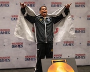 Retired U.S. Army Staff Sgt. Nathaniel Mateo celebrates winning the gold medal in powerlifting during the 2026 Warrior Games at the Henry B. González Convention Center in San Antonio.