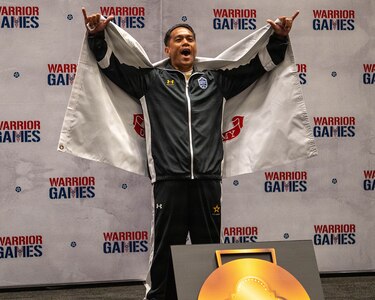Retired U.S. Army Staff Sgt. Nathaniel Mateo celebrates winning the gold medal in powerlifting during the 2026 Warrior Games at the Henry B. González Convention Center in San Antonio.