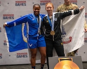 Retired U.S. Air Force Senior Airman Crystal Creek, left, and U.S. Army Staff Sgt. Chelsey Scott celebrate following the powerlifting competition at the 2026 Warrior Games at the Henry B. González Convention Center in San Antonio.
